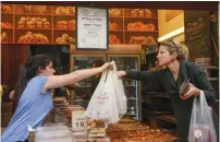  ??  ?? A CUSTOMER buys pastries at a bakery in Jerusalem. (Marc Israel Sellem/The Jerusalem Post)