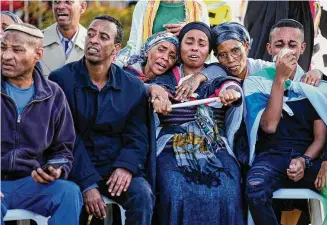  ?? Ariel Schalit/Associated Press ?? Family of Staff Sergeant Aschalwu Sama mourn during his funeral in Petah Tikva, Israel, Sunday. Sama, 20, died of his wounds after he was injured in a ground operation in the Gaza Strip.