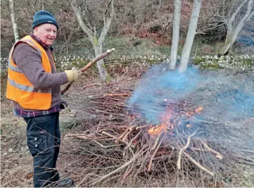  ??  ?? Brian Williams, a lineside volunteer, is seen conserving grassland by brash control. JOE STACEY