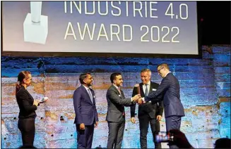  ?? ?? The ROI-EFESO INDUSTRIE 4.0 Award is presented by Dr. Lucas Johannes Winter (far right), Managing Director, Contakt GmbH, to Reda Nidhakou (centre), Senior Vice President Strategy & Portfolio Management, EDGE (AETOSWire)