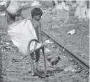  ?? Anupam Nath, The Associated Press ?? An Indian boy searches for reusable materials Friday in Gauhati, India.