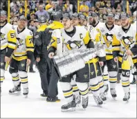  ?? AP PHOTO ?? In this June 11 photo, Pittsburgh Penguins’ Sidney Crosby celebrates with the Stanley Cup after defeating the Nashville Predators in Game 6 of the NHL Stanley Cup Final in Nashville, Tenn.