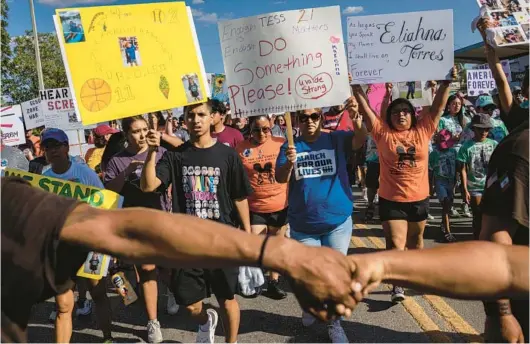  ?? TAMIR KALIFA/THE NEW YORK TIMES ?? Family members of the victims killed in the shooting at Robb Elementary School march July 10 from the school in Uvalde, Texas, to the town square.