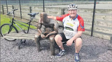  ??  ?? Tom Walker’s father, Rick pictured at the hand-sculptured memorial to Tom which is in the grounds of Charnwood College, formerly Burleigh. Tom was a student at Burleigh Community College and in his memory, his good friend Josh Burrell, created the bench in 2009, with a life-size figure of Tom