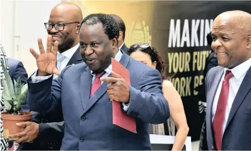  ?? ELMOND JIYANE ?? FINANCE Minister Tito Mboweni, flanked by Deputy Finance Minister Mondli Gungubele and National Treasury director-general Dondo Mogajane, arrives in Parliament to present his Budget this week. |GCIS