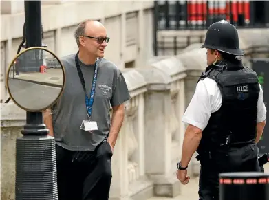  ?? AP ?? Dominic Cummings, chief adviser to Britain’s Prime Minister Boris Johnson, chats to a police officer in Downing Street, London. Cummings is backing new technology to capture carbon in the atmosphere and store it undergroun­d to assist in the battle against climate change and to help meet Britain’s 2050 commitment on emissions.