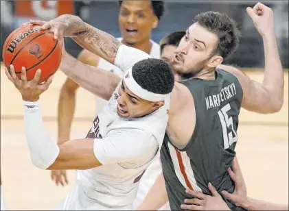  ?? John Locher The Associated Press ?? Arizona State forward Jalen Graham pulls a rebound away from Washington State center Volodymyr Markovetsk­yy in the first half of the Sun Devils’ 64-59 win Wednesday at T-mobile Arena.