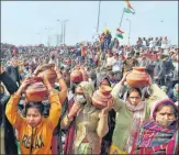  ?? ANI ?? Women bring pitchers of water to the Ghazipur protest site on Saturday. Hundreds of people rushed in with pitchers after farm leader Rakesh Tikait responded to Thursday’s water and power supply cut, saying water would come from west UP’S villages.