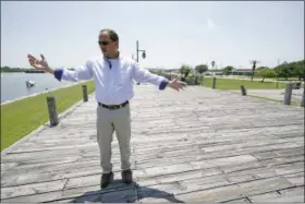  ?? DAVID J. PHILLIP — THE ASSOCIATED PRESS ?? Resident Engineer Steve Sherrill, with the US Army Corps of Engineers, talks about the project to raise some of the levees and seawalls in the area Thursday in Port Arthur, Texas. As the nation plans new defenses against the more powerful storms and higher tides expected from climate change, one project stands out: an ambitious proposal to build a nearly 60-mile “spine” of concrete seawalls, earthen barriers, floating gates and steel levees on the Texas Gulf Coast.