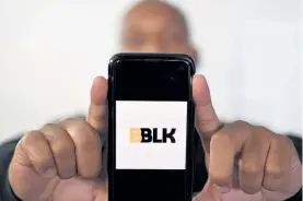  ??  ?? Ramond Murphy, co-founder of the BBLK app, displays the logo on his cell phone.