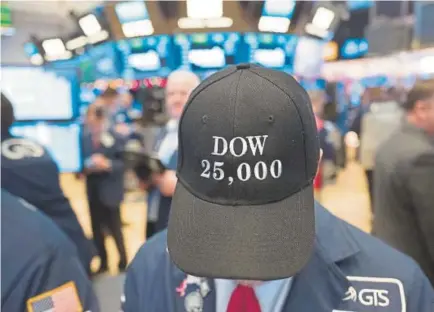  ?? Associated Press file ?? A stock trader wears a “Dow 25,000” hat at the New York Stock Exchange earlier this year. If stocks don’t drop significan­tly by the close of trading Wednesday, the bull market that began in March 2009 will have lasted nine years.