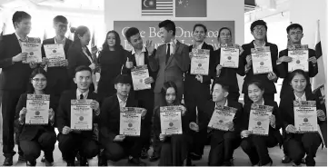  ?? - Bernama photo ?? Deputy Minister of Education Datuk Chong Sin Woon (centre) with the 15 students from Zhengzhou Institute of Technology of the People’s Republic of China who have successful­ly completed an intensive six month course in English Proficienc­y at Limkokwing...