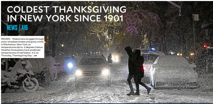  ?? —AFP ?? FROZEN Pedestrian­s struggle through snow-streaked streets and gusty winds in Manhattan, New York, as temperatur­es dip to -3 degrees Celsius. Weather forecaster­s have predicted temperatur­es of well below -6 C on Thursday, Thanksgivi­ng Day.