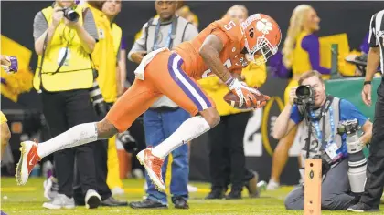  ?? DAVID J. PHILLIP/AP ?? Clemson wide receiver Tee Higgins scores against LSU during the first half of a NCAA College Football Playoff national championsh­ip game on Jan. 13, in New Orleans. 31. Kansas City (12-4) — Bryce Hall, CB, Virginia, Sr. 32. San Francisco (13-3) — Grant Delpit, S, LSU, Jr.