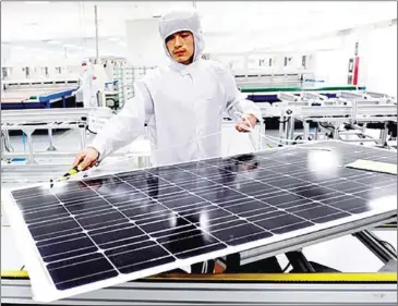  ?? LIANG ZHEN/CHINA DAILY ?? An employee works at a Chint Group solar panel production plant in Zhejiang province’s Hangzhou city in China.