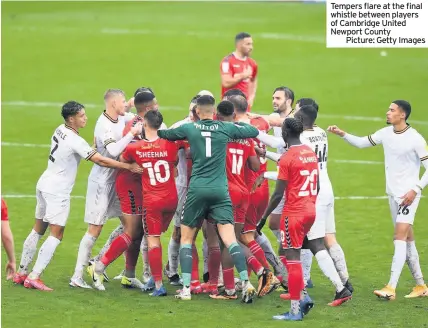  ??  ?? Tempers flare at the final whistle between players of Cambridge United Newport County
Picture: Getty Images