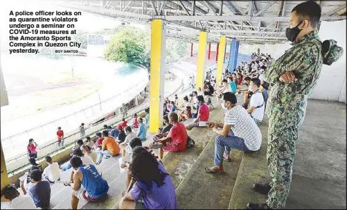  ?? BOY SANTOS ?? A police officer looks on as quarantine violators undergo a seminar on COVID-19 measures at the Amoranto Sports Complex in Quezon City yesterday.