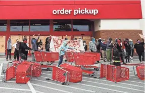  ?? LOLA GOMEZ/AUSTIN AMERICAN-STATESMAN ?? On May 31, the day a peaceful demonstrat­ion was planned for the Texas Capitol in Austin, another event was created to protest at a Target store. An hour into the demonstrat­ion, the store was looted.