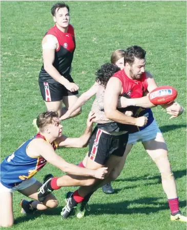  ??  ?? Warragul defender Jake Hughes spills the ball in a strong Moe tackle during Saturday’s important senior clash at Western Park. The Moe pressure on the Gulls at the contests played a big part in it wearing down the Gulls to post a strong win.