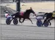  ?? PAUL POST — MEDIANEWS GROUP ?? Horses speed around the harness track at Saratoga Casino Hotel.