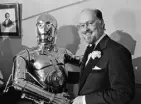  ?? Associated Press file ?? Composer-conductor John Williams shakes hands with Star Wars character C-3PO in Boston in 1980.