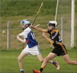  ??  ?? Odhran Kehoe of Ballyhogue about to strike as Ballygarre­tt’s Harry Smyth attempts to block.