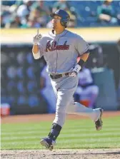  ?? THE ASSOCIATED PRESS ?? Atlanta’s Kurt Suzuki celebrates after hitting a home run off Oakland’s John Axford in the 12th inning Sunday. The Braves won 4-3 to sweep the three-game series.