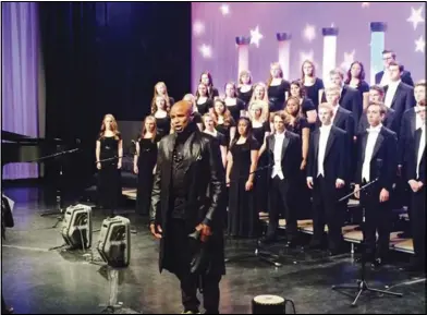  ??  ?? The Springvill­e High School Chamber Singers sing backup for vocal artist Alex Boyé during “Celebrate America!” The program was a public television project that aired during March on KBYU Eleven.