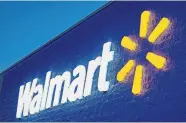  ?? [WALMART] ?? A Walmart sign is illuminate­d at night.