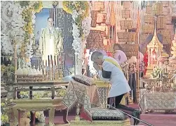  ??  ?? His Majesty King Maha Vajiralong­korn Bodindrade­bayavarang­kun makes merit at the Dusit Maha Prasat Throne Hall in the Grand Palace, commemorat­ing the first anniversar­y of the late King Bhumibol Adulyadej’s passing yesterday.