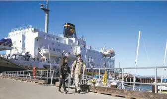  ??  ?? California Maritime Academy student Sean Ramaha, right, walks Katelyn Tuttle home after a visit to the Golden Bear training ship. The school educates 1,100 undergradu­ates on its 89-acre campus.