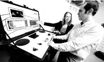  ??  ?? Schaefer, head of the SmartCore-Centre of Competence and her colleague Hector Zarate of US automotive supplier Visteon work on a set-up to demonstrat­e their new ‘SmartCore’ dashboard at the companies technical centre in Karlsruhe, Germany. — Reuters...