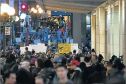  ?? Picture: REUTERS ?? RALLY TOGETHER: People walk towards Westlake Park for a protest held in response to President Donald Trump's travel ban, in Seattle, Washington, US on Sunday