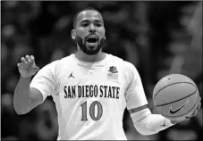  ?? AP PHOTO/ORLANDO RAMIREZ ?? In this 2019, file photo, San Diego State guard KJ Feagin gestures as he dribbles the ball during the second half of an NCAA college basketball game against Cal Poly in San Diego.