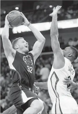  ?? Gerald Herbert Associated Press ?? THERE WAS no stopping Clippers forward Blake Griffin (32), who finished with 27 points and 10 rebounds. Terrence Jones was among the Pelicans who tried.