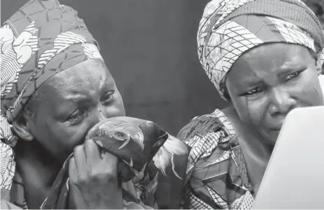  ?? PHOTO: CNN ?? File photo of two parents identifyin­g their daughters in one of the videos posted by Boko Haram on the abducted Chibok girls.