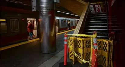  ?? CRAIG F. WALKER/GLOBE STAFF ?? Stairs were cordoned off at the station after an insulation panel fell from the ceiling.