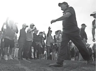  ?? PATRICK BREEN/THE REPUBLIC ?? Phil Mickelson walks off the ninth hole greeted by fans during first round of the Waste Management Phoenix Open at TPC Scottsdale on Jan. 31, 2019.