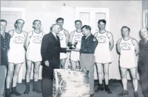  ?? GLEN WHIFFEN/THE TELEGRAM ?? Sandra Green’s father, Thomas Gordon, (second from left) is pictured during a trophy presentati­on at the Royal St. John’s Regatta in the 1940s.