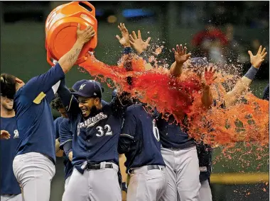  ?? AP/AARON GASH ?? Hernan Perez of the Milwaukee Brewers douses teammates with Gatorade after they walked off on the Chicago Cubs 4-3 on Monday in Milwaukee.