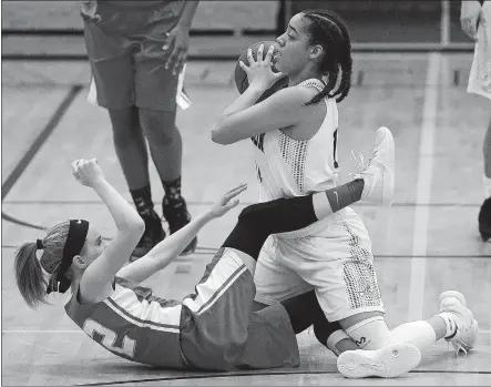  ?? SARAH GORDON/THE DAY ?? New London’s Spencer Roman steals the ball from NFA’s Riley Ellington during the Whalers’ 57-28 win in Wednesday’s ECC Division I girls’ basketball tournament final at Plainfield High School.