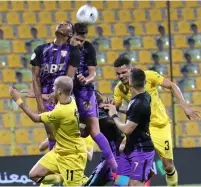  ??  ?? Al Ain and Al Wasl players in an aerial battle in Dubai. — AGL