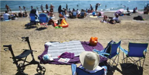  ?? BEN STANSALL/AFP VIA GETTY IMAGES ?? “My hunch is that most Americans think sunlight and heat kill the virus and you can be outdoors without risk, but if you’re in a group, even outside, you can spread and contract the virus,” says one researcher.