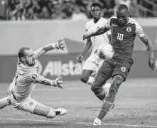  ?? Godofredo A. Vásquez / Staff photograph­er ?? Canada keeper Milan Borjan, left, tries in vain to stop Haiti midfielder Wilde-Donald Guerrier from scoring in the 76th minute during Haiti’s win in a Gold Cup quarterfin­al match.