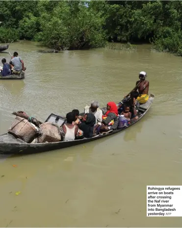  ??  ?? Rohingya refugees arrive on boats after crossing the Naf river from Myanmar into Bangladesh yesterday