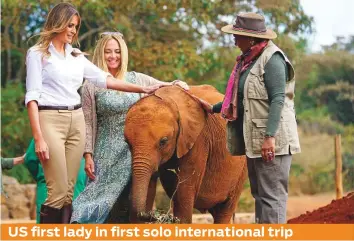  ?? AP ?? United States first lady Melania Trump and Margaret Kenyatta, the first lady of Kenya, pet a baby elephant at the David Sheldrick Elephant &amp; Rhino Orphanage at the Nairobi National Park in Nairobi, Kenya, yesterday. The US first lady is visiting Africa on her first big solo internatio­nal trip.