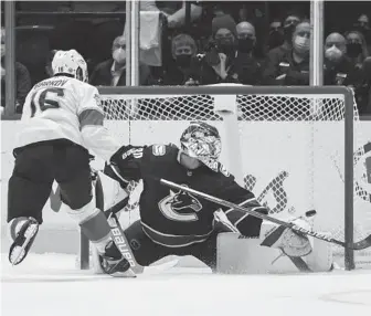  ?? DARRYL DYCK/AP ?? The Panthers’ Aleksander Barkov scores against Canucks goalie Spencer Martin during the shootout in a game Friday in Vancouver, British Columbia.