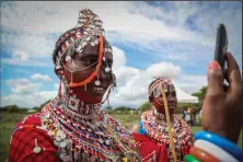  ?? ?? A Maasai woman takes a selfie Dec. 10 as she prepares to watch the Maasai
Olympics.