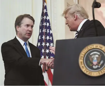  ?? AP PHOTO ?? CONGRATULA­TIONS, JUSTICE: President Trump shakes hands with Supreme Court Justice Brett Kavanaugh before a ceremonial swearing-in in the East Room of the White House yesterday.