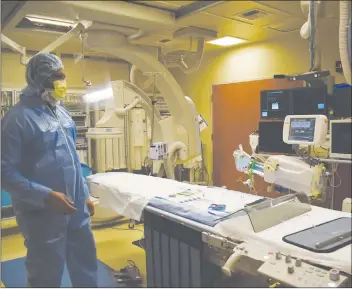  ??  ?? Eric Cooper stands in the cath lab at Adventist Health/rideout, which recently received American College of Cardiology accreditat­ion.